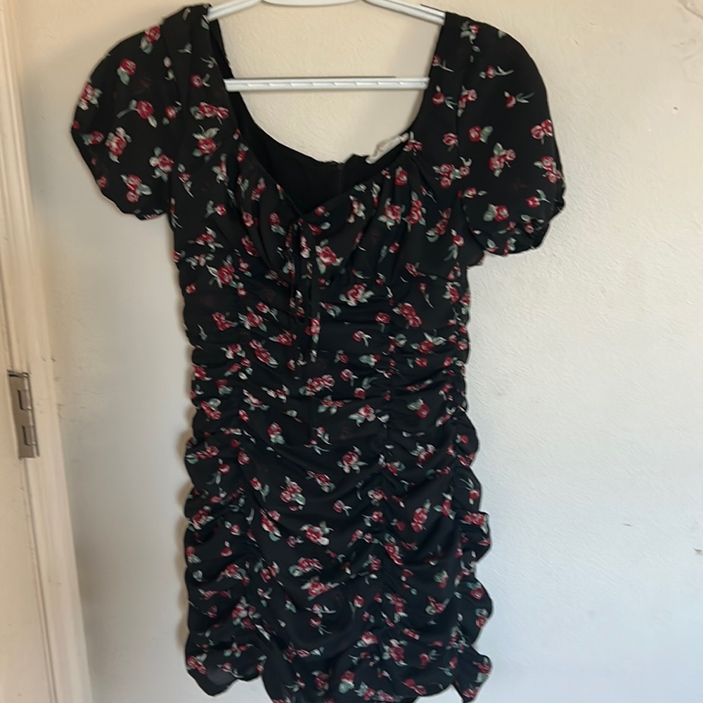 Black bodycron dress, with ruffled middle area.